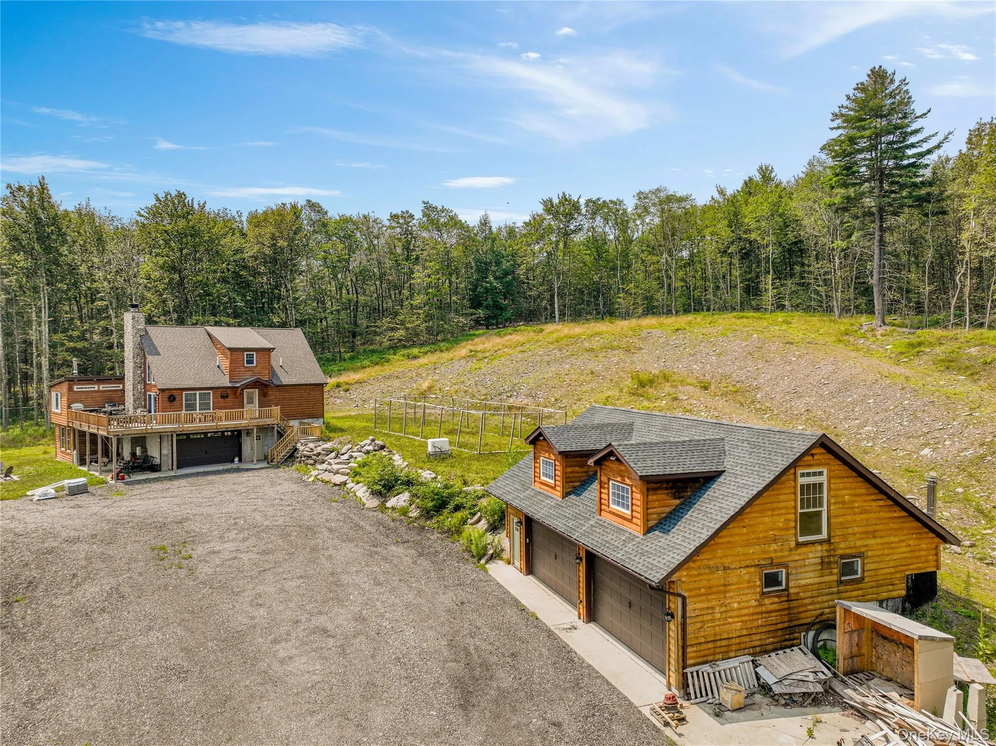 Aerial view of property and surrounding area with a heavily wooded area Aerial view of property and surrounding area with a heavily wooded area