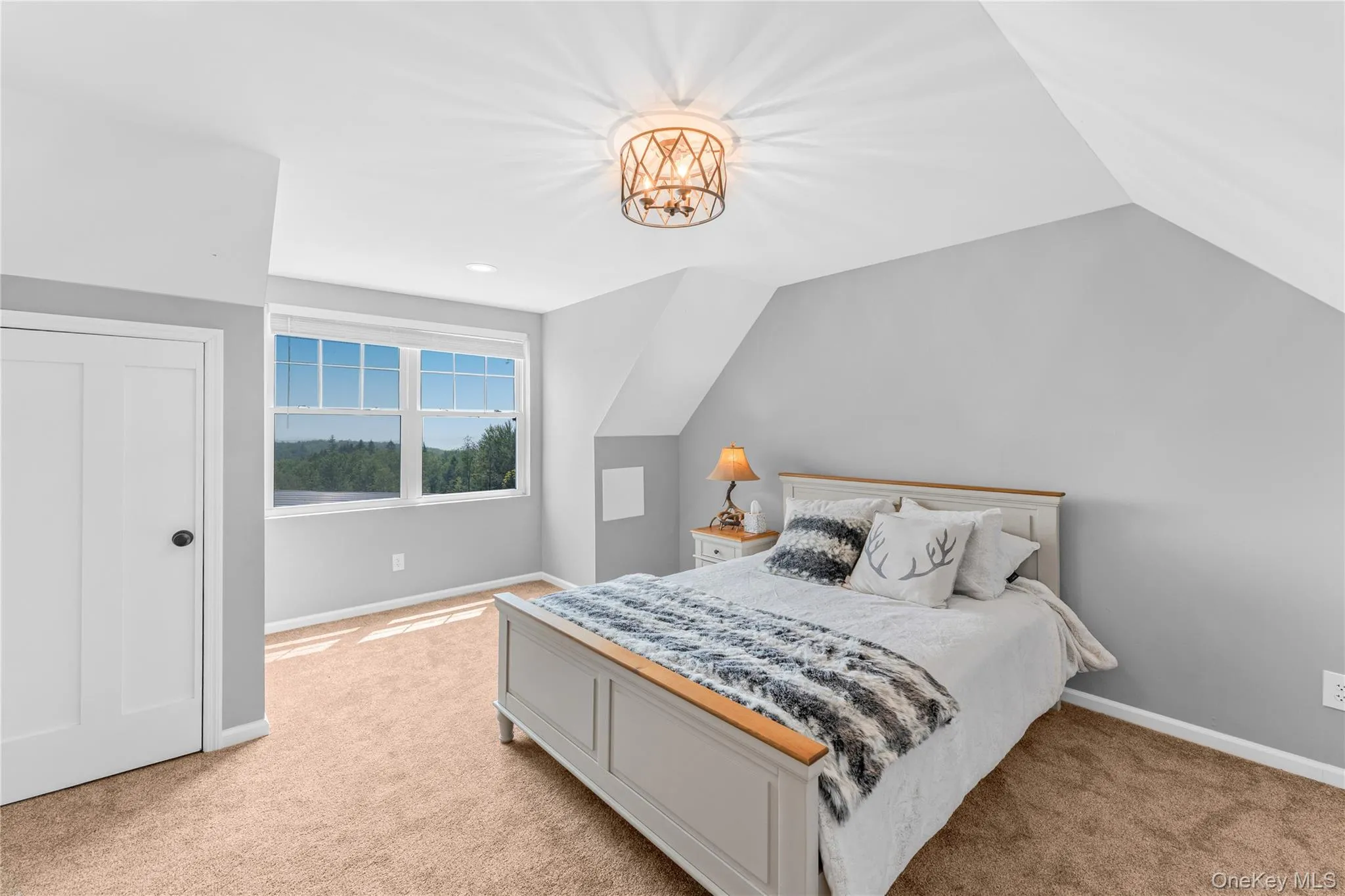 Bedroom 4 featuring lofted ceiling, light carpet, and a chandelier Bedroom 4 featuring lofted ceiling, light carpet, and a chandelier