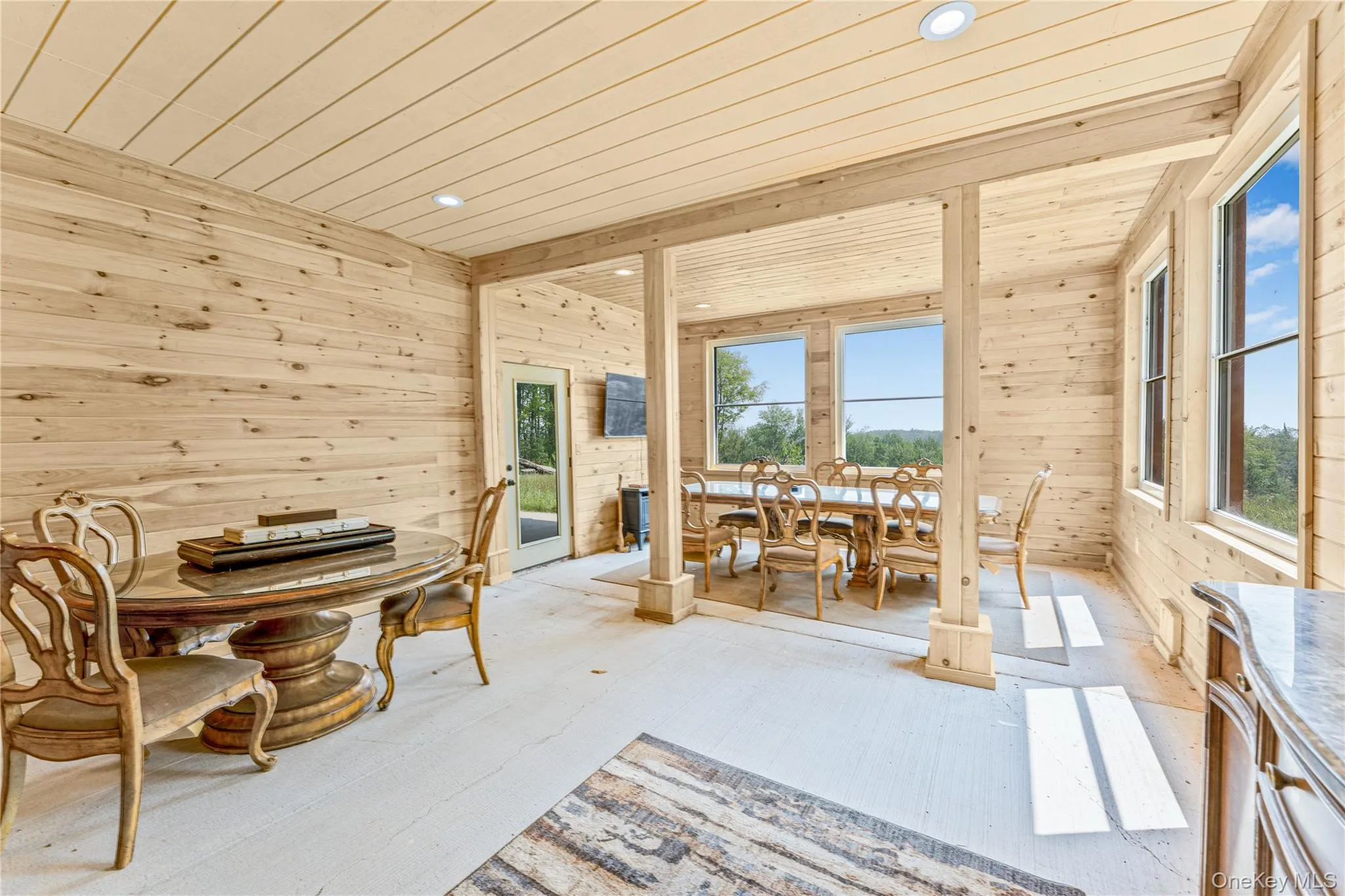 Entertainment area featuring wooden walls, wood ceiling, and recessed lighting Entertainment area featuring wooden walls, wood ceiling, and recessed lighting