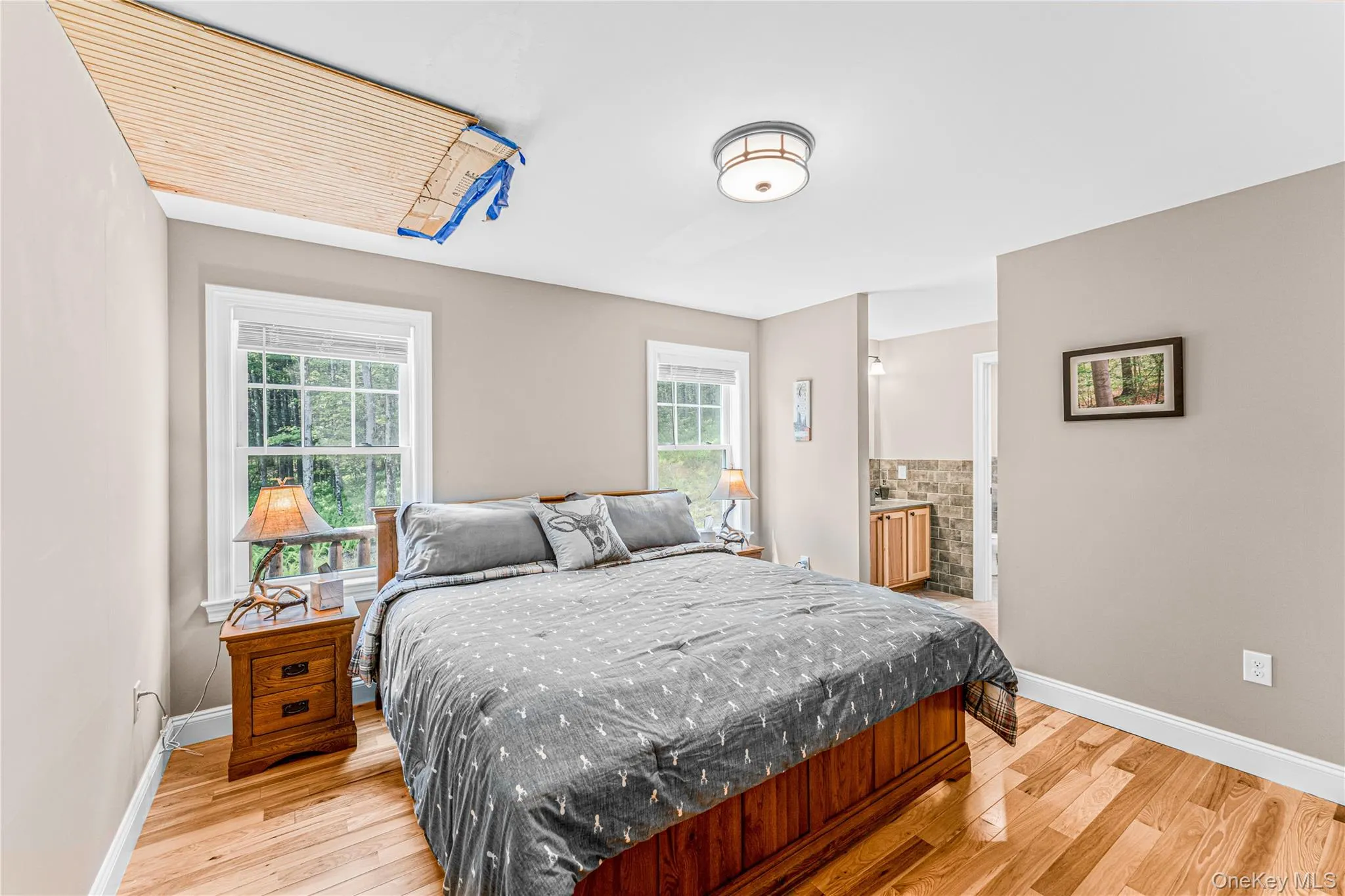 Primary Bedroom 1 with light wood-style flooring and connected bathroom Primary Bedroom 1 with light wood-style flooring and connected bathroom