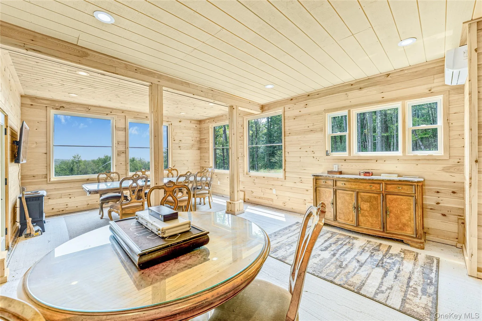 Entertainment area with wooden walls, wood ceiling, recessed lighting, light wood finished floors, and a wall mounted AC Entertainment area with wooden walls, wood ceiling, recessed lighting, light wood finished floors, and a wall mounted AC