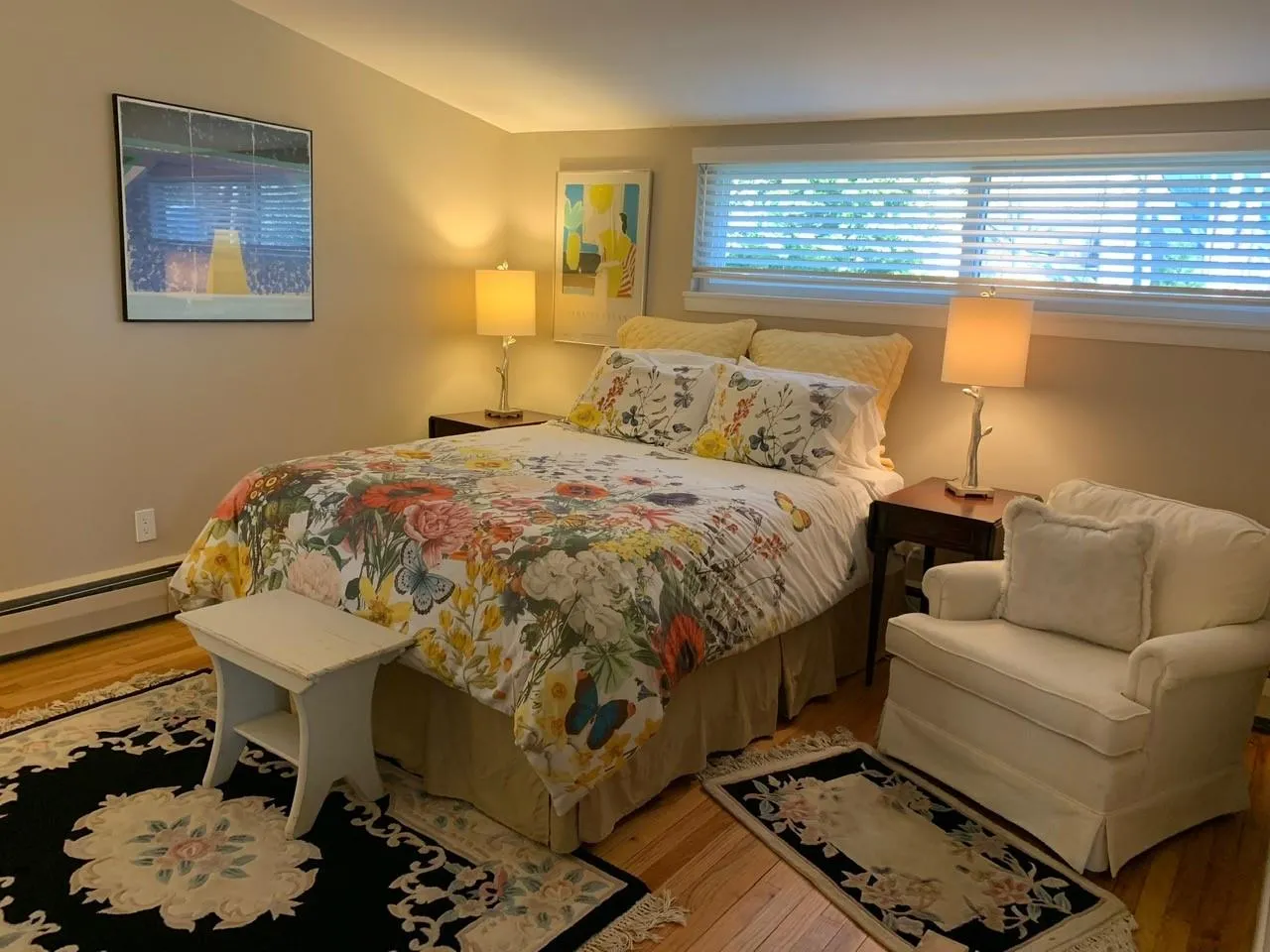 Bedroom with lofted ceiling, a baseboard heating unit, and light hardwood / wood-style floors Bedroom with lofted ceiling, a baseboard heating unit, and light hardwood / wood-style floors