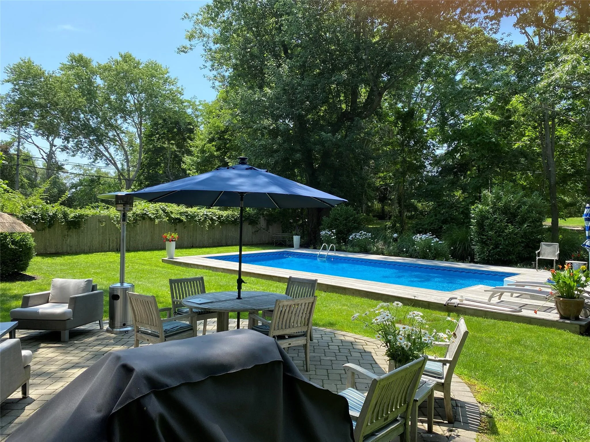 View of pool with area for grilling, a patio, and a lawn View of pool with area for grilling, a patio, and a lawn