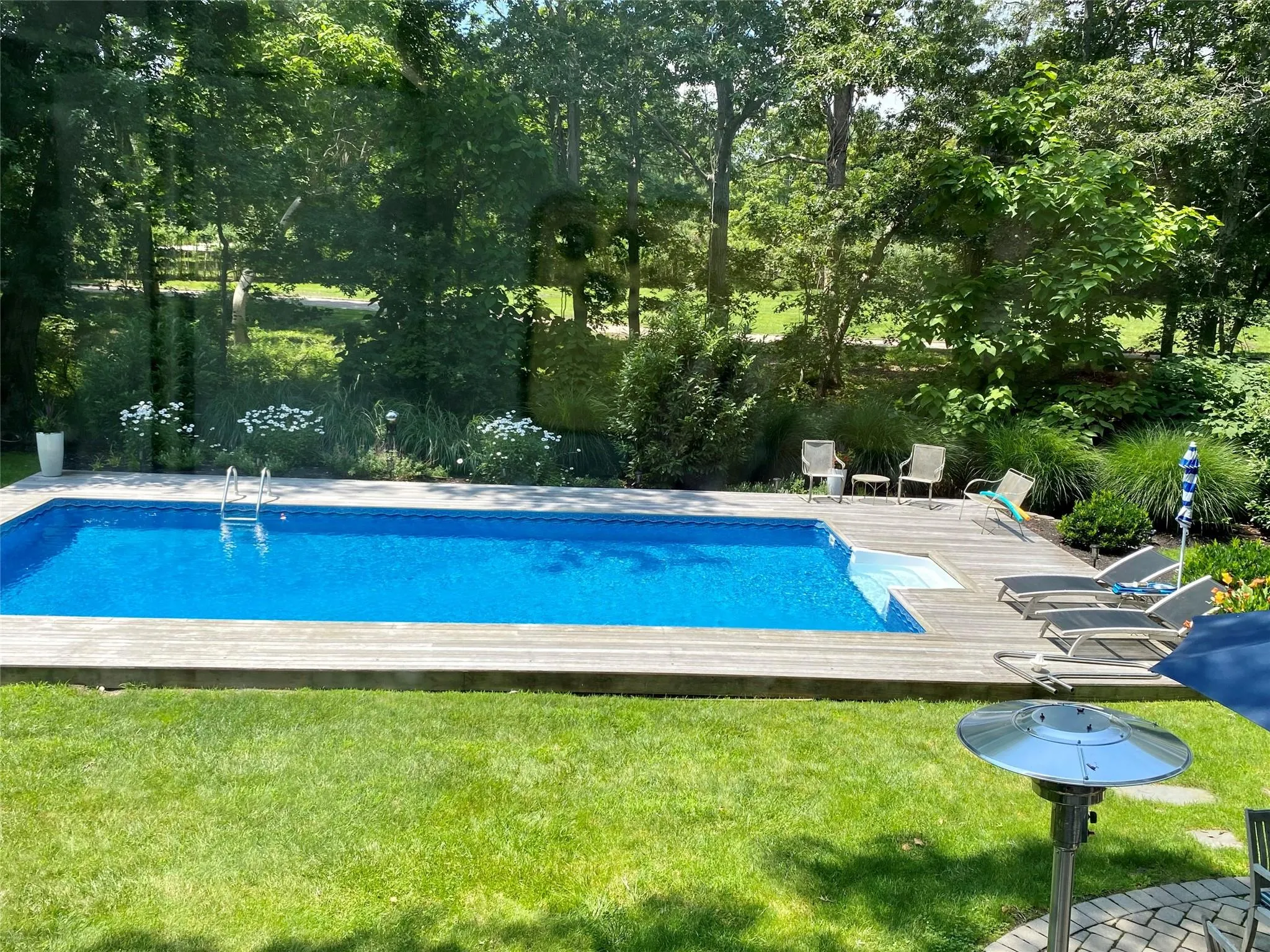 View of swimming pool with a yard and a deck View of swimming pool with a yard and a deck