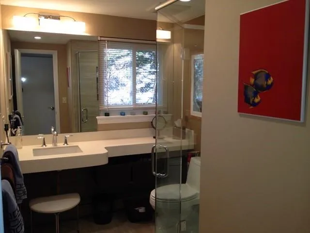 Bathroom with vanity, toilet, and a shower with door Bathroom with vanity, toilet, and a shower with door