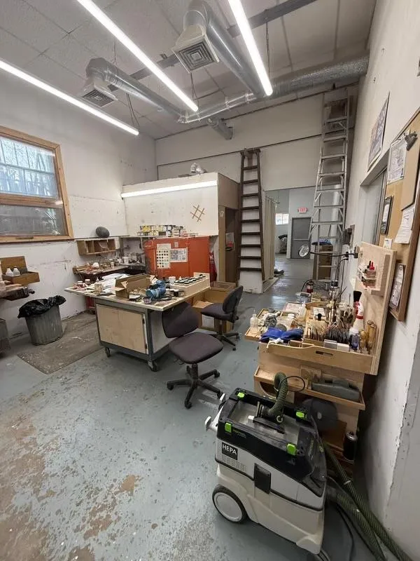 Garage with visible vents and a workshop area Garage with visible vents and a workshop area