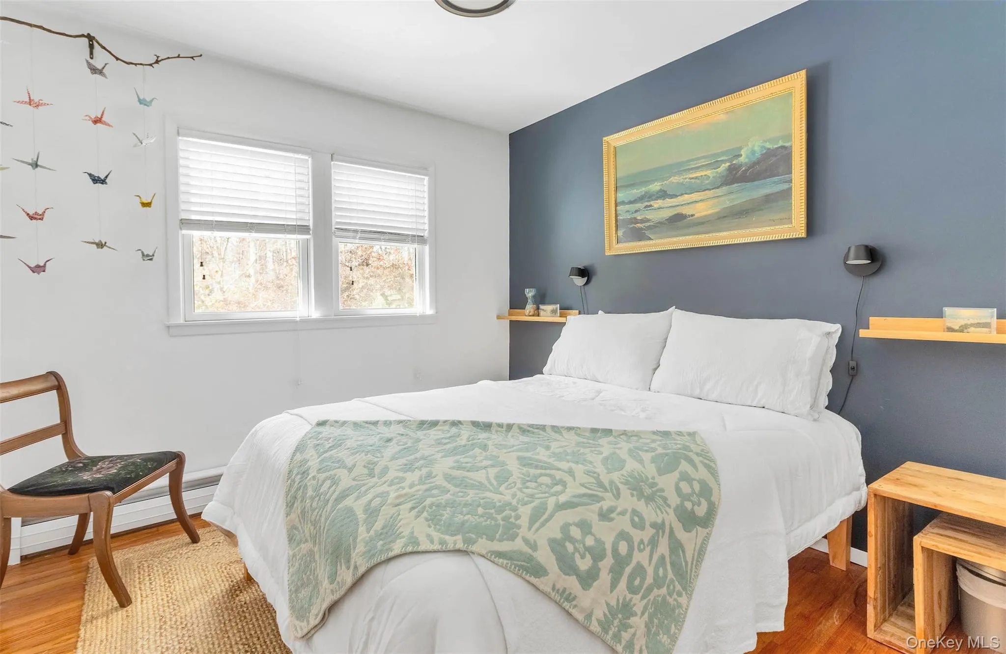 Bedroom with hardwood / wood-style flooring and a baseboard radiator Bedroom with hardwood / wood-style flooring and a baseboard radiator