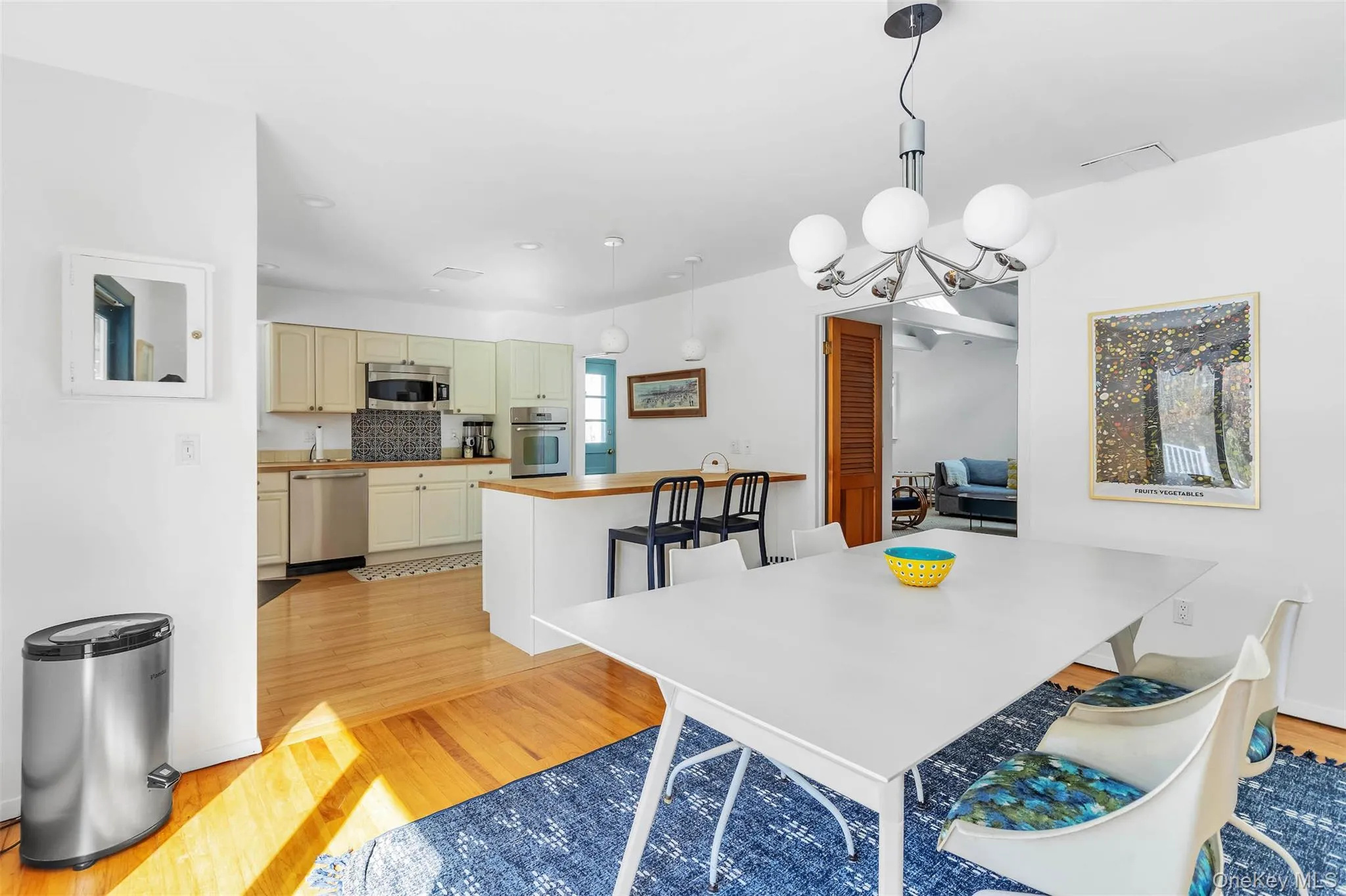 Dining space with a chandelier and light hardwood / wood-style flooring Dining space with a chandelier and light hardwood / wood-style flooring