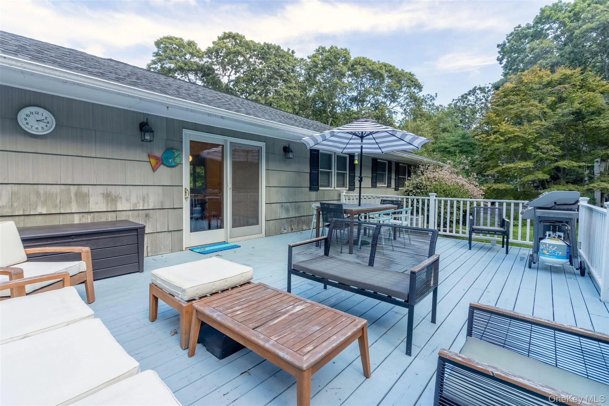 Wooden terrace featuring grilling area and an outdoor living space Wooden terrace featuring grilling area and an outdoor living space