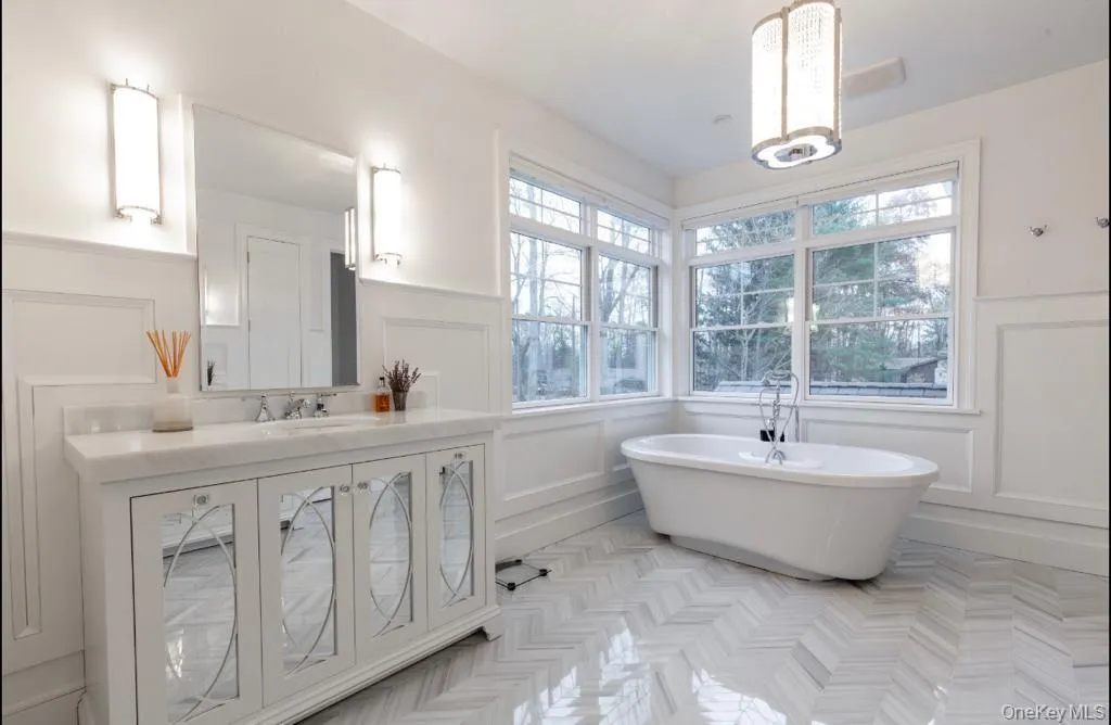 Rendering of full bath with wainscoting, a decorative wall, and a freestanding tub Rendering of full bath with wainscoting, a decorative wall, and a freestanding tub