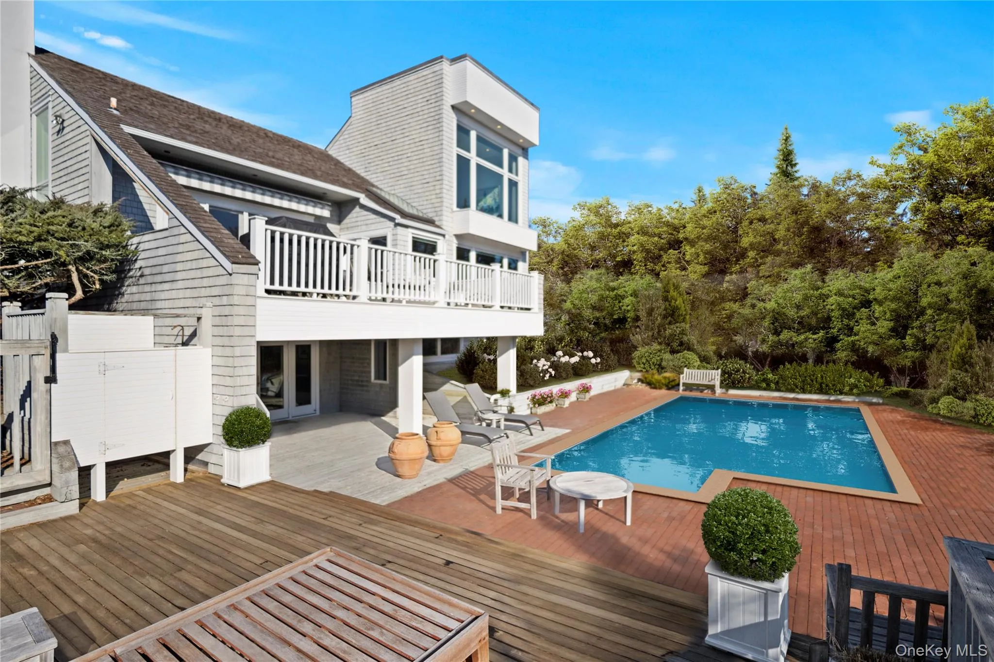 View of pool featuring french doors and a deck View of pool featuring french doors and a deck