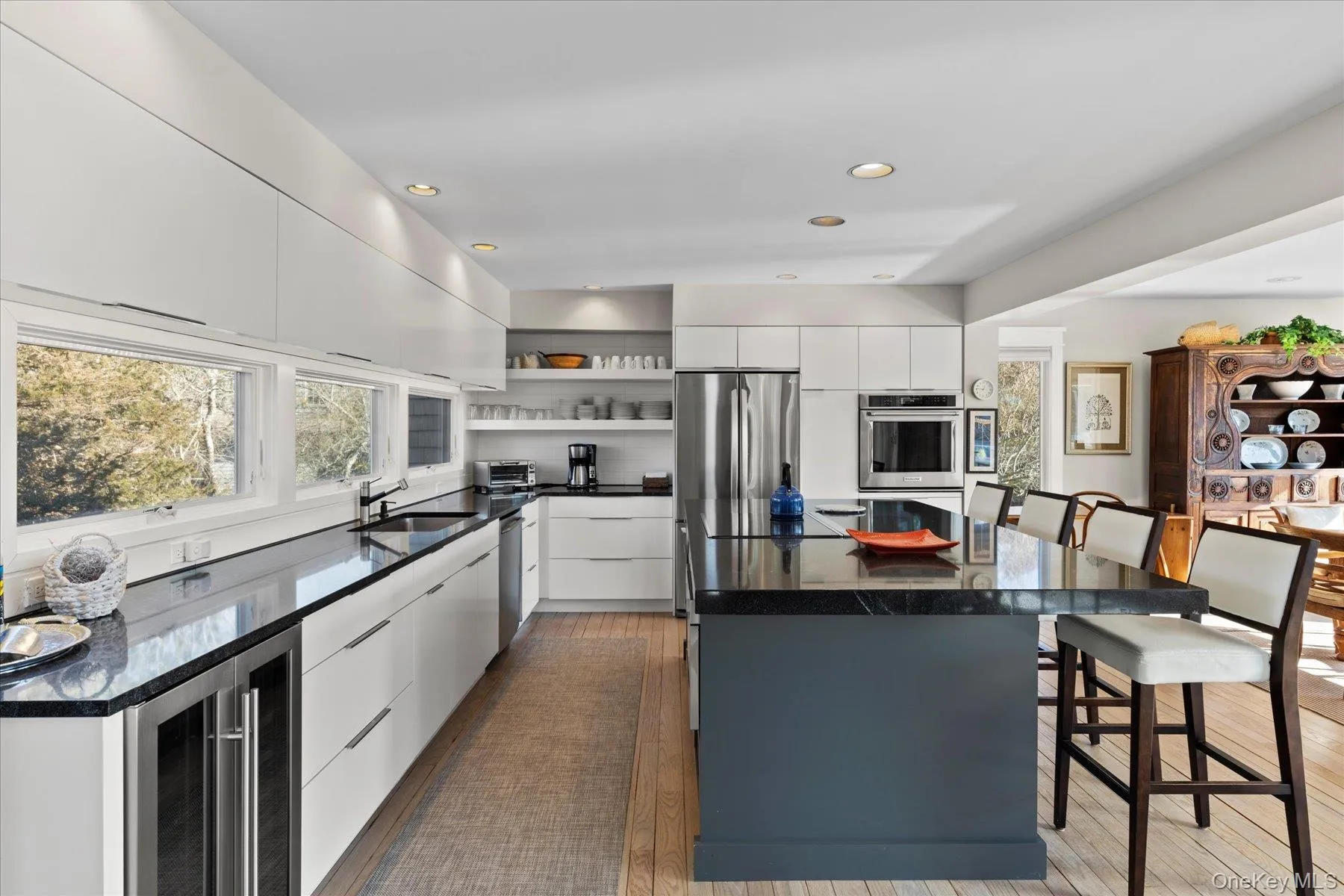 Kitchen featuring white cabinets stainless appliances with stainless steel finishes, a center island, Kitchen featuring white cabinets stainless appliances with stainless steel finishes, a center island,
