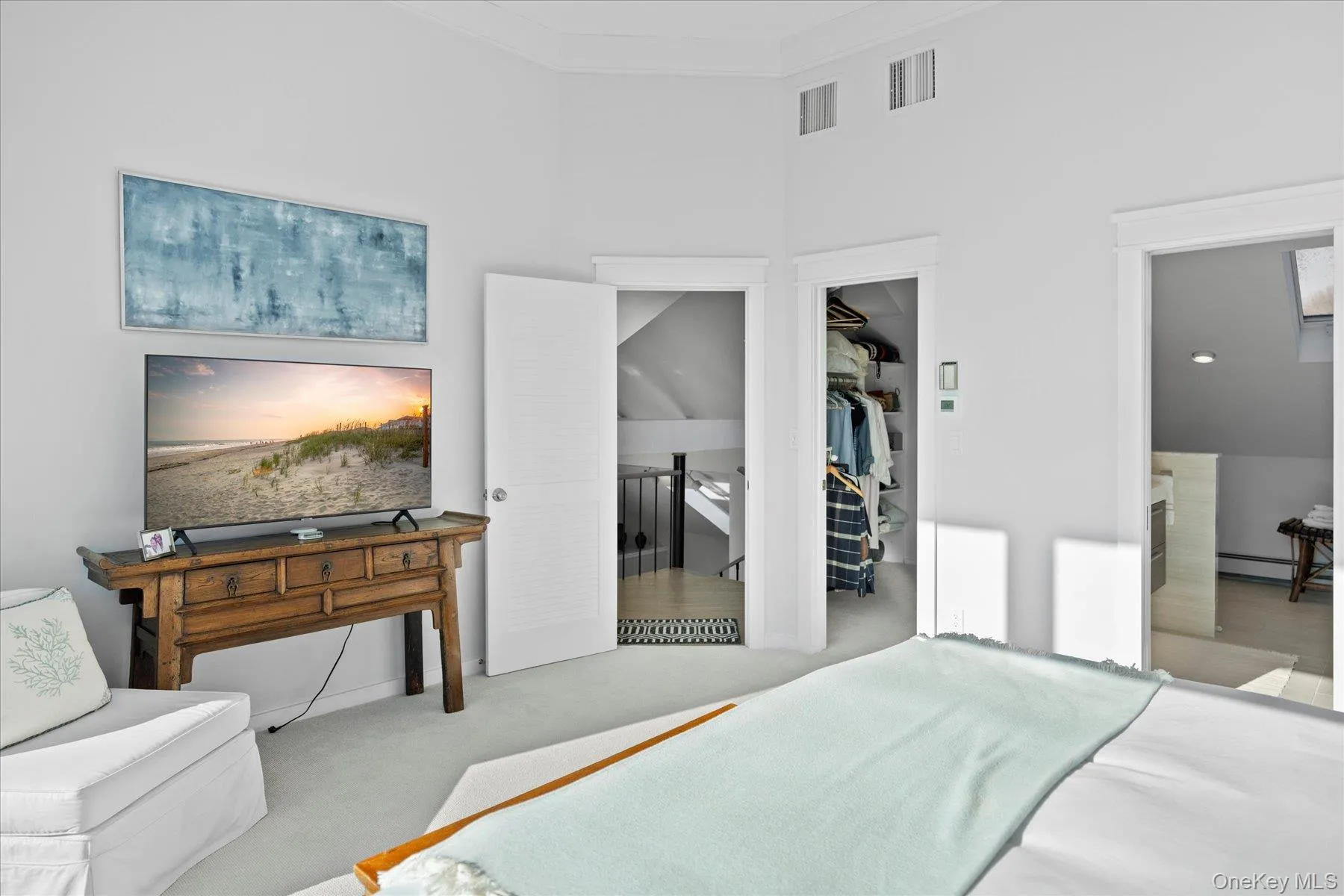 Carpeted prmary bedroom featuring a closet, a high ceiling, connected bathroom, and crown molding and spacious closet Carpeted prmary bedroom featuring a closet, a high ceiling, connected bathroom, and crown molding and spacious closet