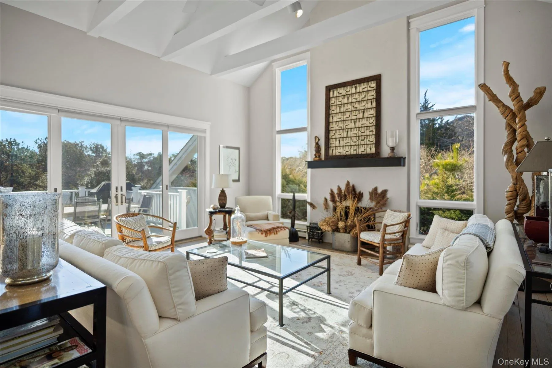 Living room with vaulted ceiling with beams and window walls with views Living room with vaulted ceiling with beams and window walls with views