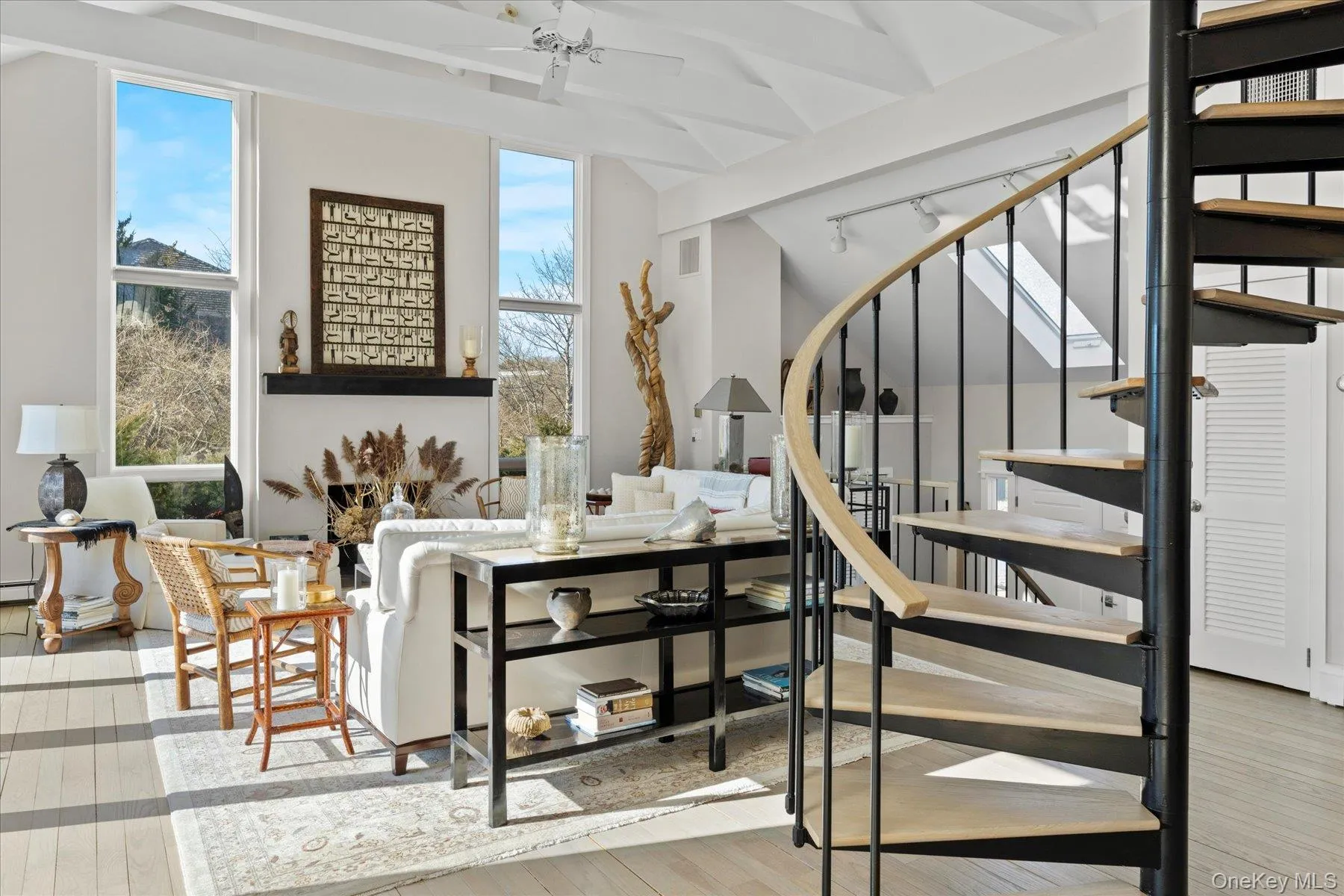 Living room with vaulted ceiling with beams and light hardwood / wood-style floors Living room with vaulted ceiling with beams and light hardwood / wood-style floors