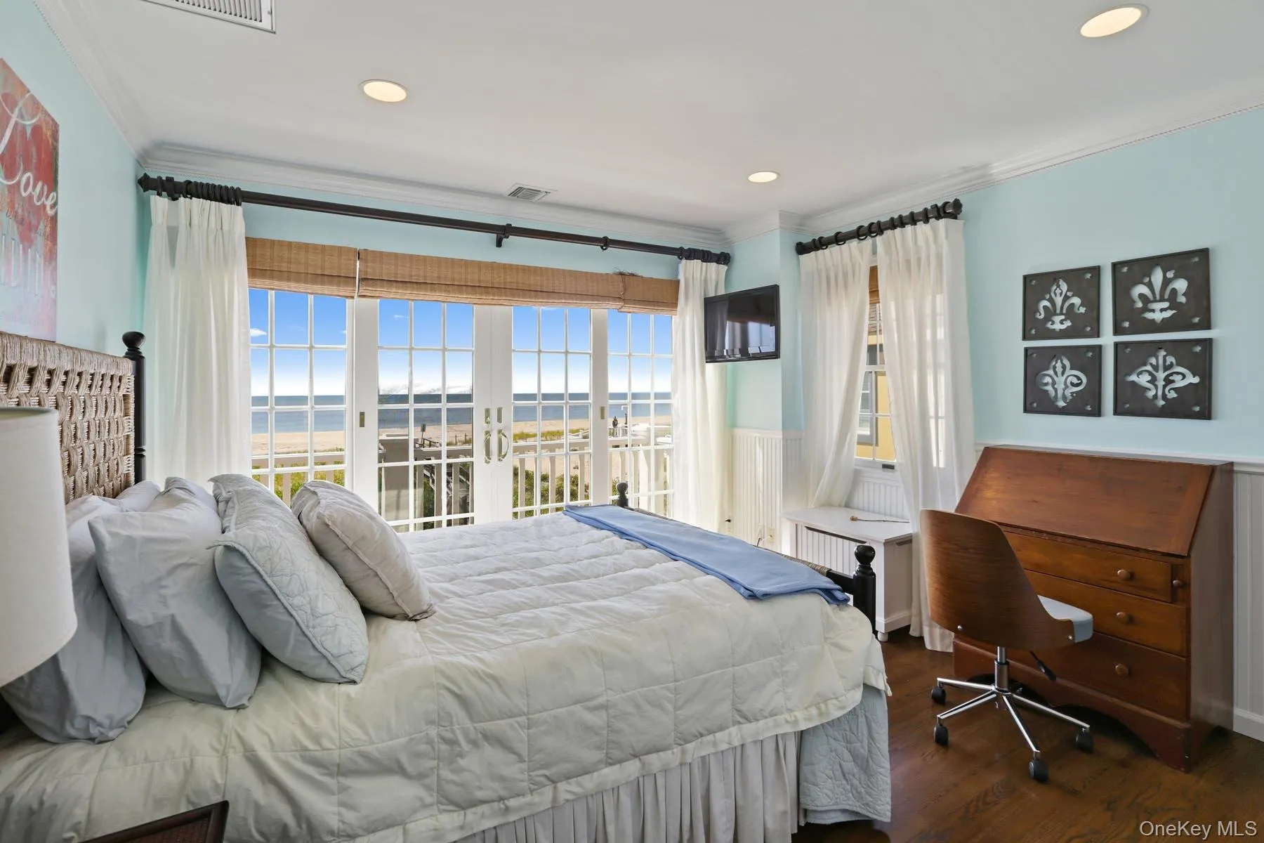 Bedroom featuring crown molding, a water view, access to outside, and dark hardwood / wood-style flooring Bedroom featuring crown molding, a water view, access to outside, and dark hardwood / wood-style flooring