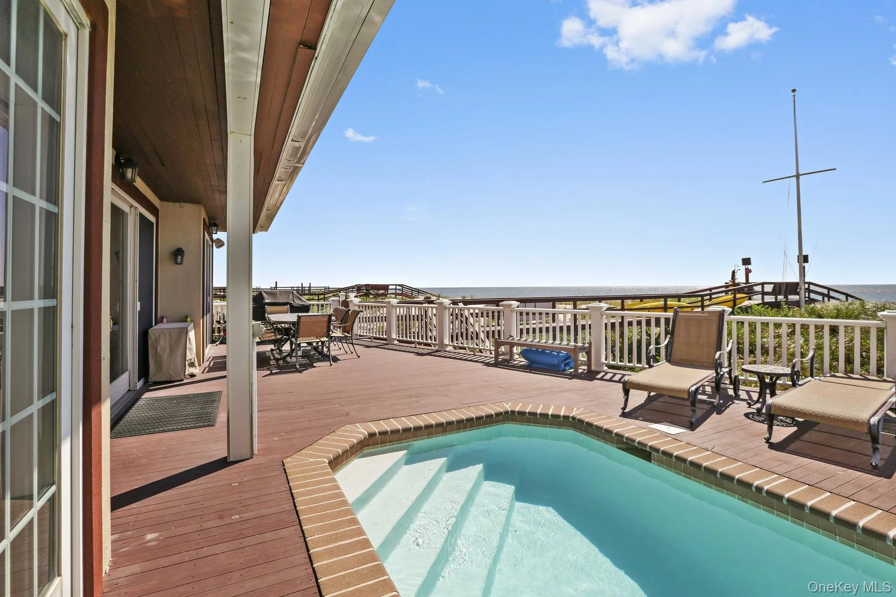 View of swimming pool featuring a deck with water view View of swimming pool featuring a deck with water view