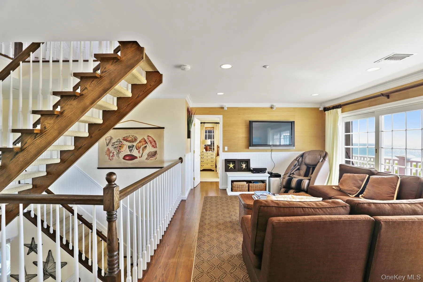 Living room featuring ornamental molding and wood-type flooring Living room featuring ornamental molding and wood-type flooring