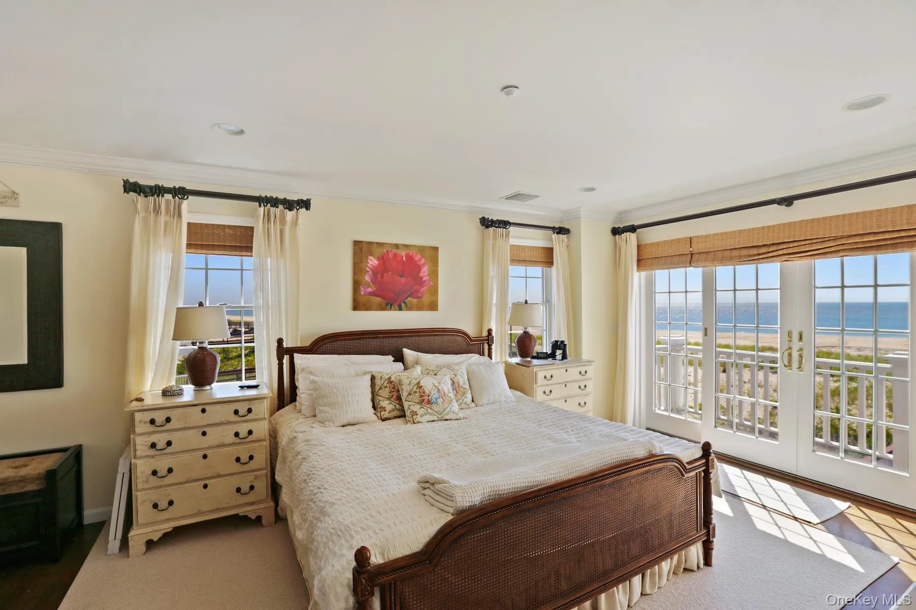 Bedroom with multiple windows, crown molding, a water view, and access to exterior Bedroom with multiple windows, crown molding, a water view, and access to exterior