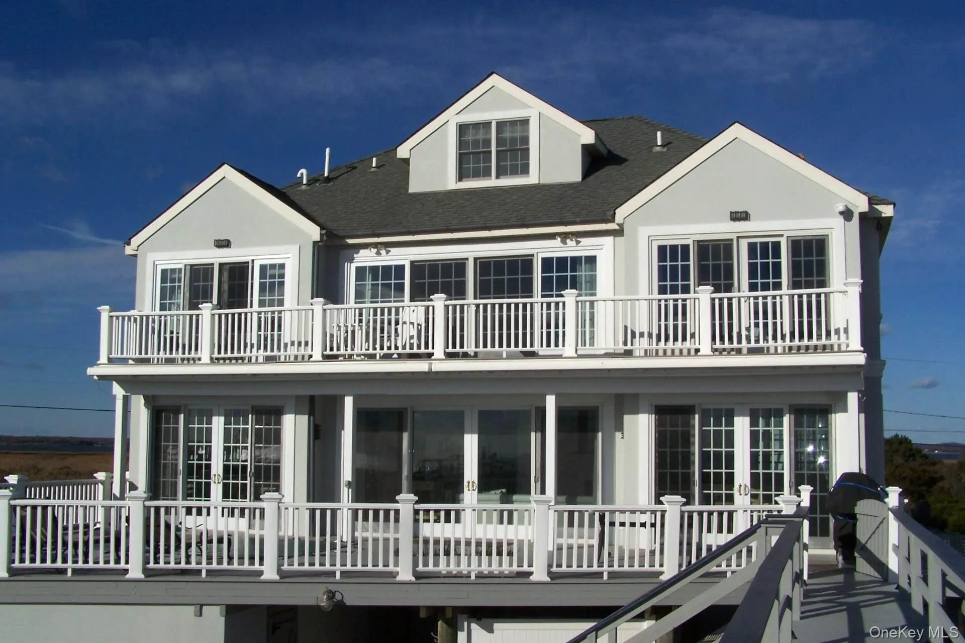 Rear view of house with a balcony and french doors Rear view of house with a balcony and french doors