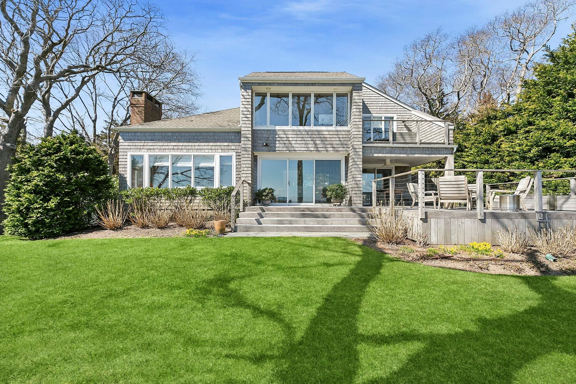 Rear view of house featuring a yard and a balcony Rear view of house featuring a yard and a balcony