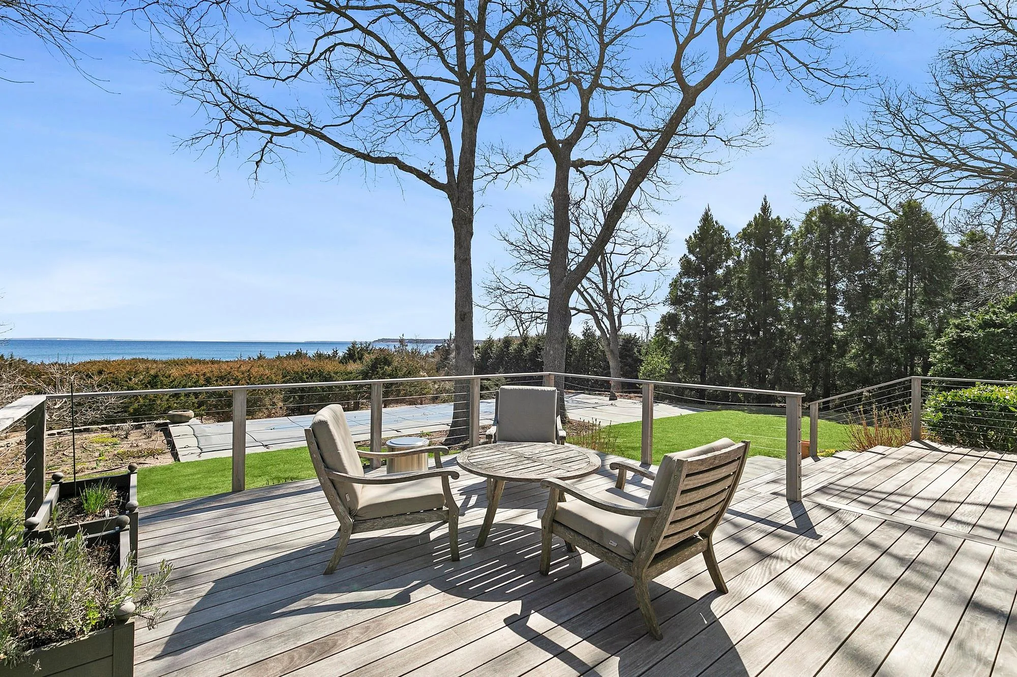 Deck with a yard and a water view Deck with a yard and a water view