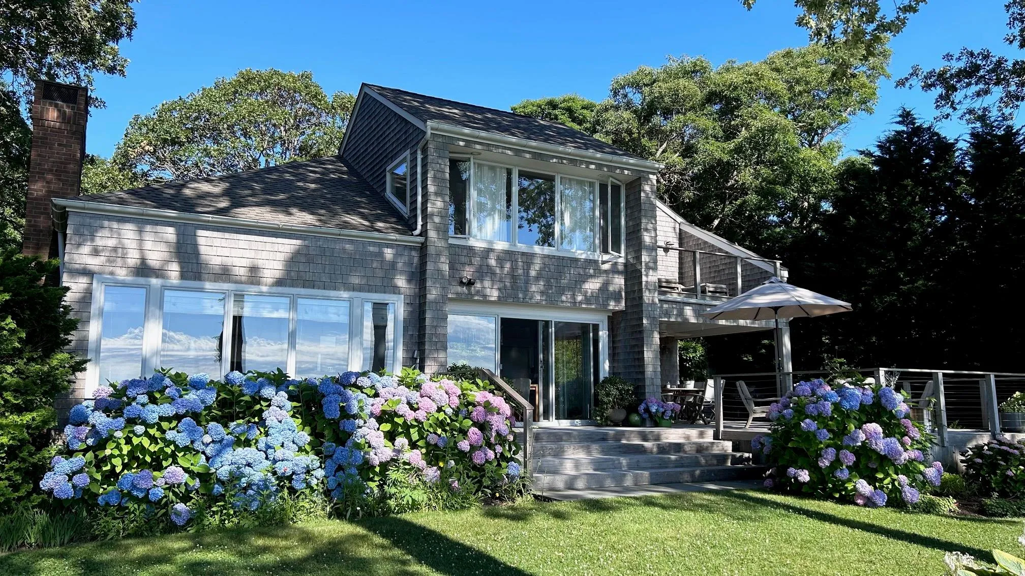 Back of property with a lawn and a balcony Back of property with a lawn and a balcony