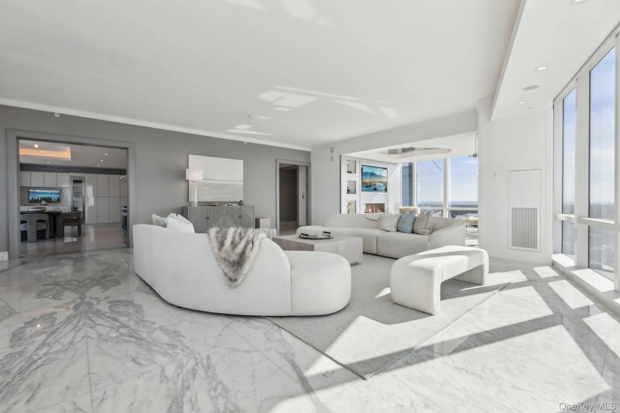 Living room featuring marble finish floor, plenty of natural light Living room featuring marble finish floor, plenty of natural light