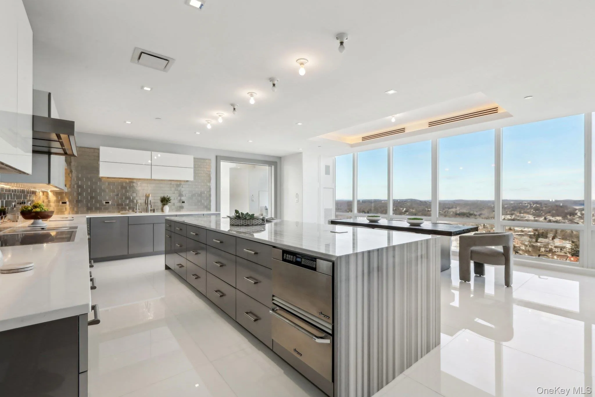Kitchen with a warming drawer, tasteful backsplash, gray cabinets, a kitchen island, and modern cabinets Kitchen with a warming drawer, tasteful backsplash, gray cabinets, a kitchen island, and modern cabinets