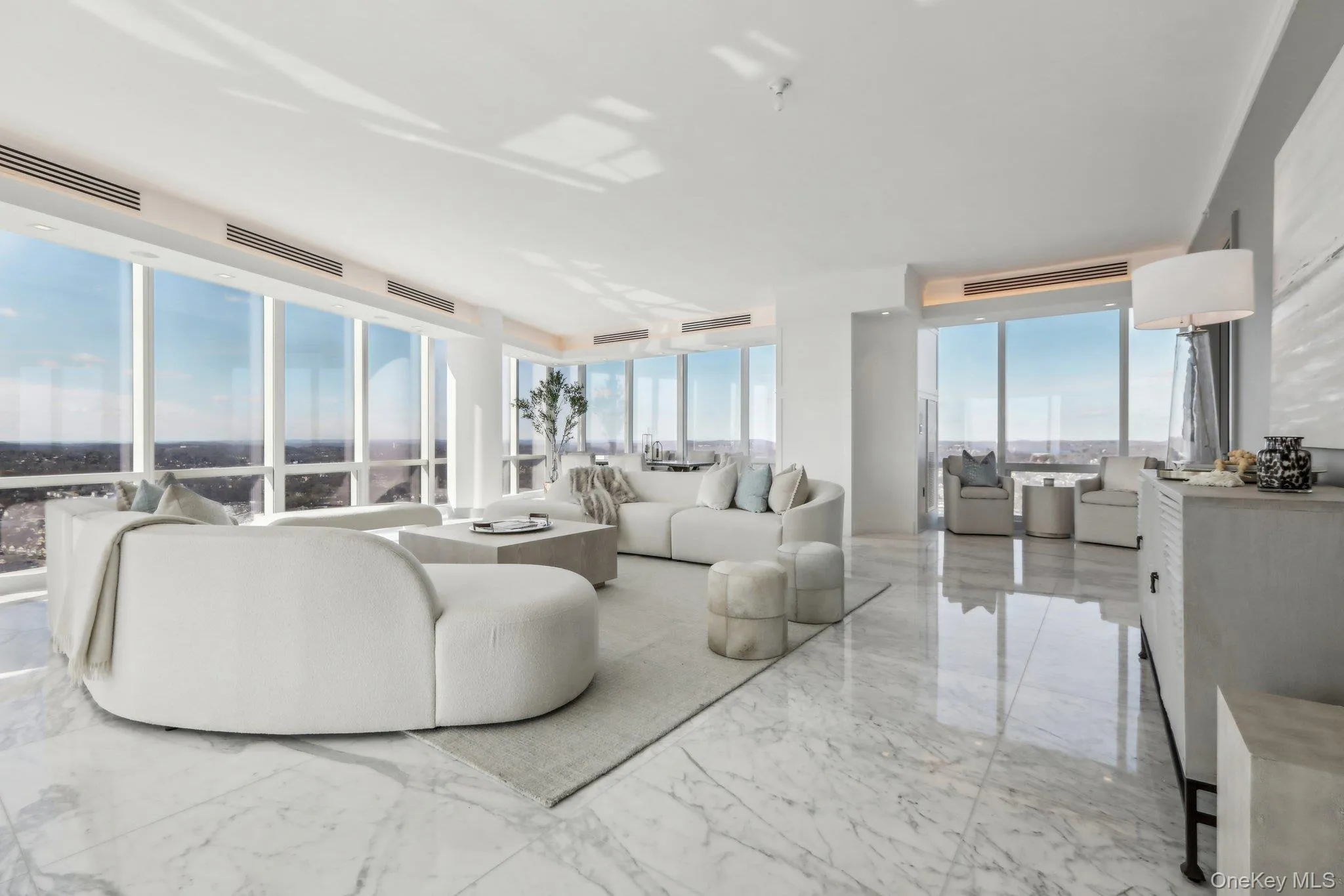 Living room featuring marble finish floor, plenty of natural light Living room featuring marble finish floor, plenty of natural light