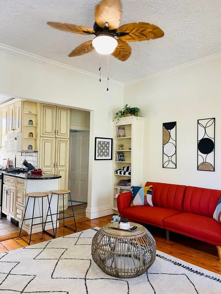 Living room featuring crown molding, a textured ceiling, and light hardwood / wood-style flooring Living room featuring crown molding, a textured ceiling, and light hardwood / wood-style flooring
