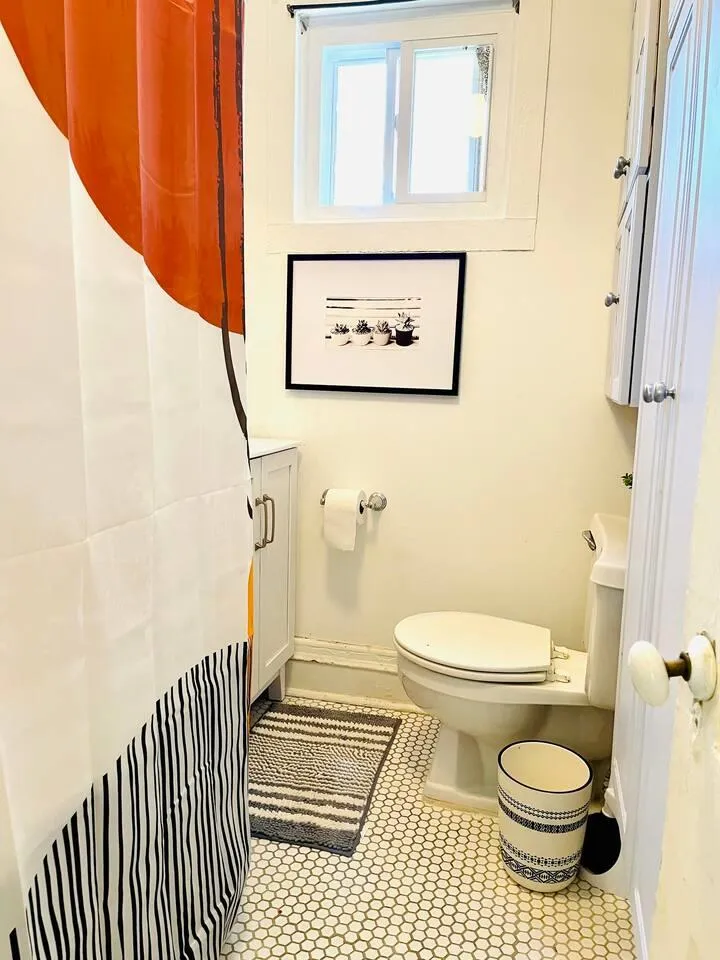 Bathroom featuring tile patterned floors and toilet Bathroom featuring tile patterned floors and toilet