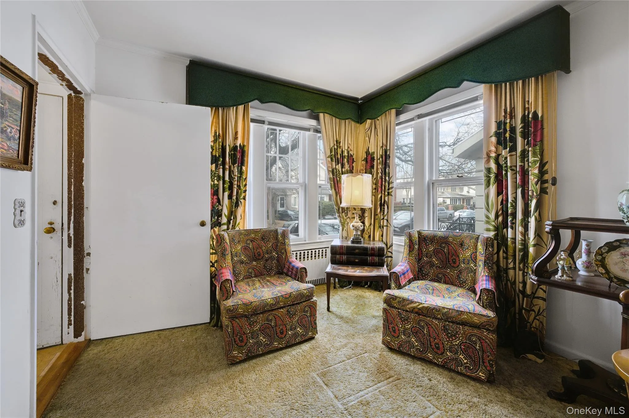 Sitting room with radiator, ornamental molding, and carpet flooring Sitting room with radiator, ornamental molding, and carpet flooring