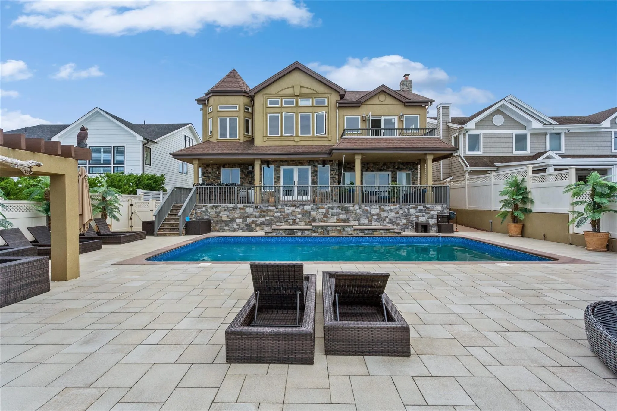Back of house featuring a patio area and a fenced in pool Back of house featuring a patio area and a fenced in pool