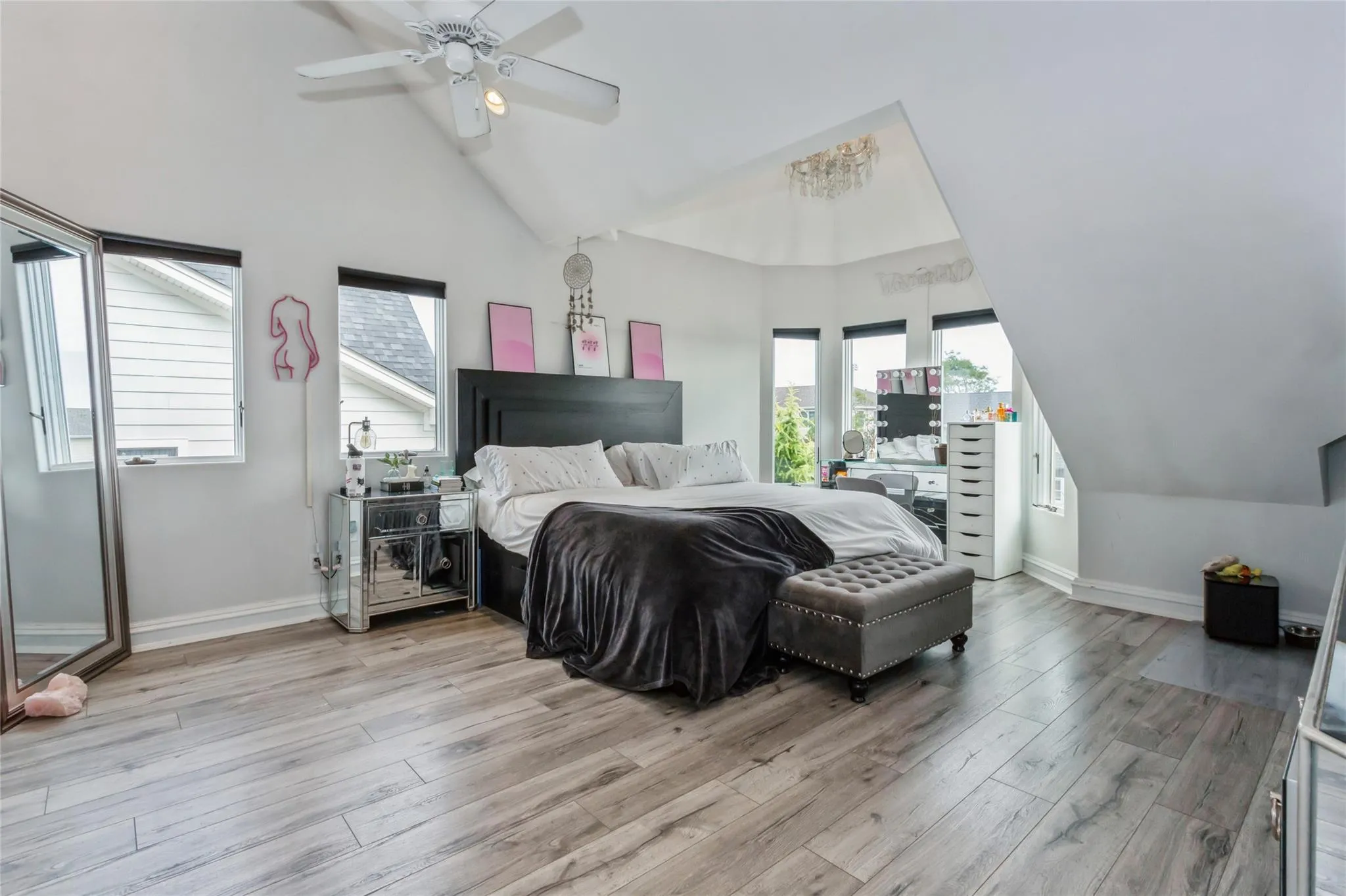Bedroom featuring ceiling fan, high vaulted ceiling, and light hardwood / wood-style floors Bedroom featuring ceiling fan, high vaulted ceiling, and light hardwood / wood-style floors