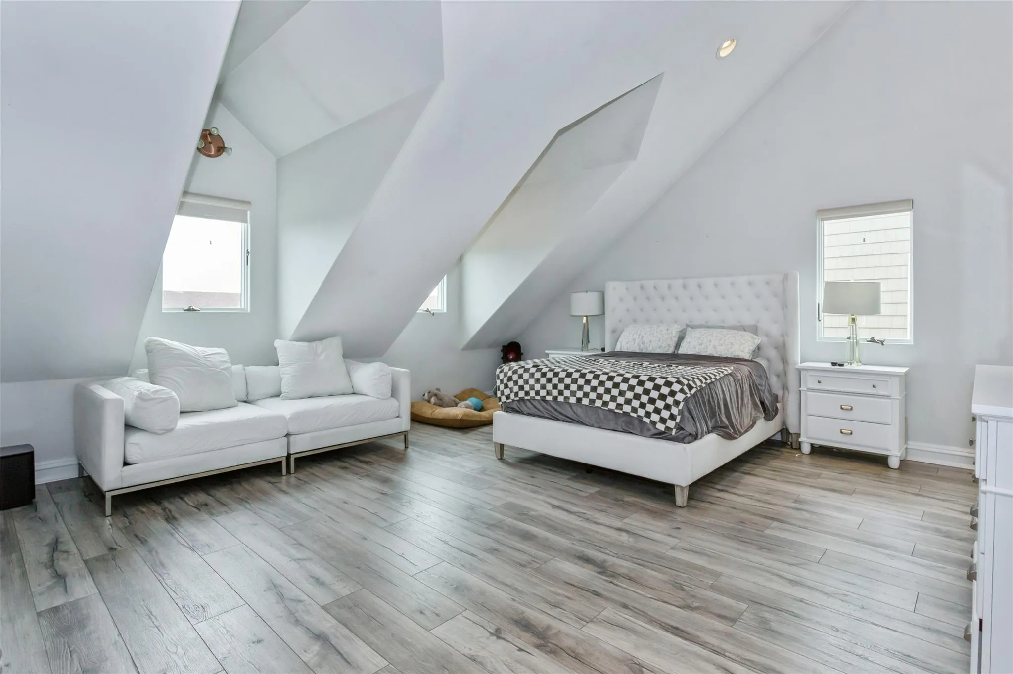Bedroom with light hardwood / wood-style flooring and vaulted ceiling Bedroom with light hardwood / wood-style flooring and vaulted ceiling