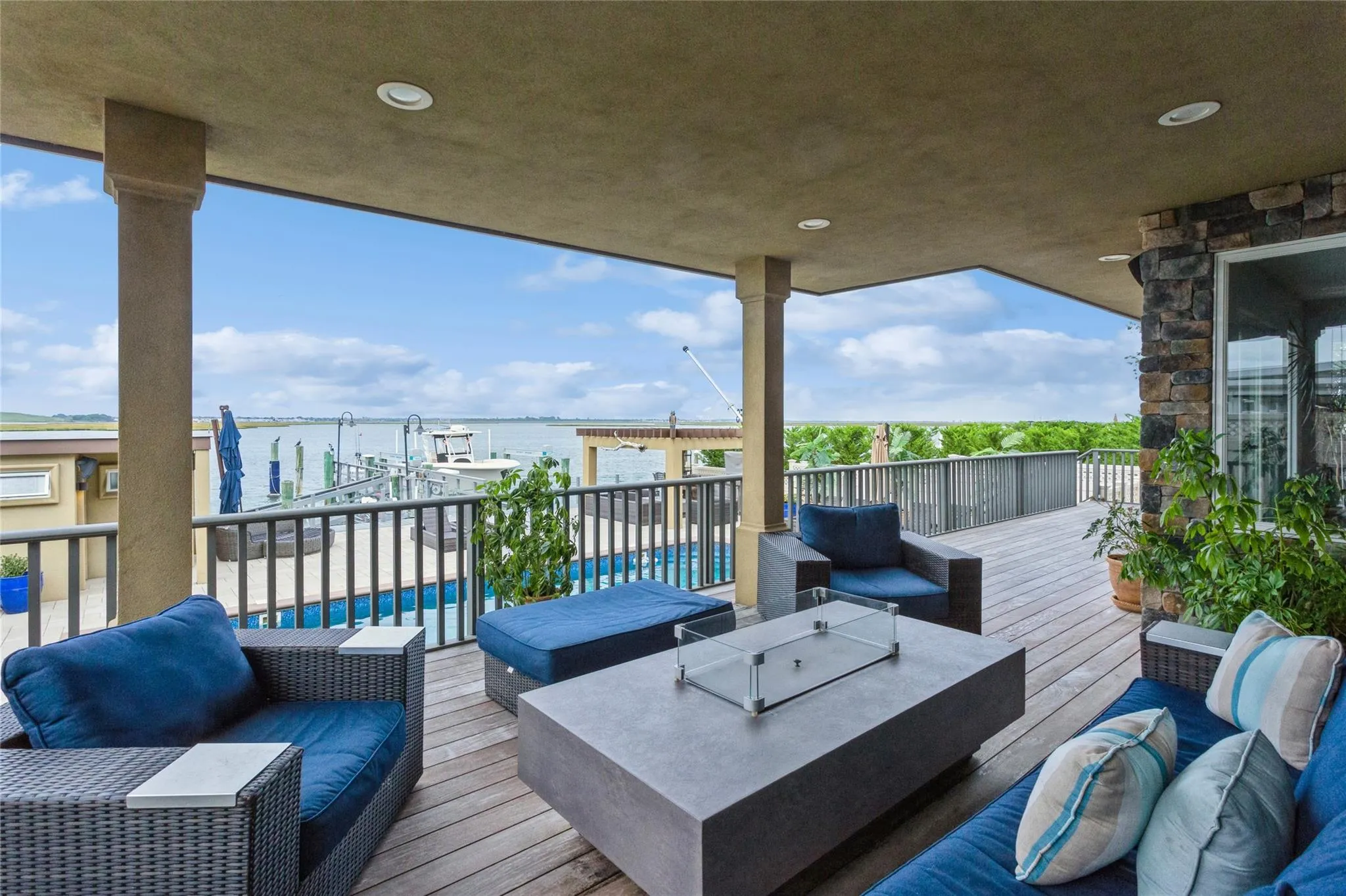 Deck featuring a fenced in pool, an outdoor living space, and a water view Deck featuring a fenced in pool, an outdoor living space, and a water view