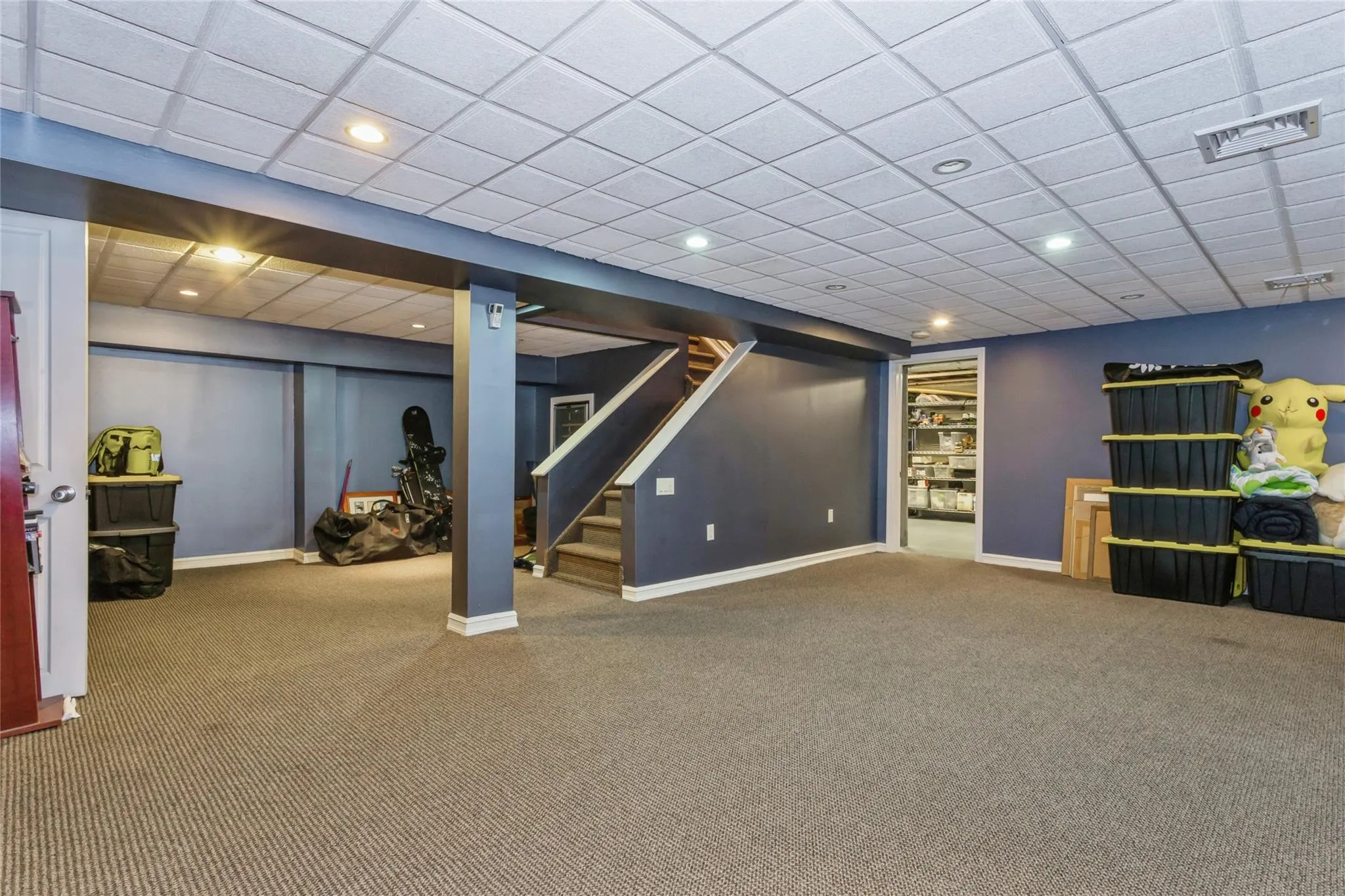Basement featuring carpet flooring and a paneled ceiling Basement featuring carpet flooring and a paneled ceiling