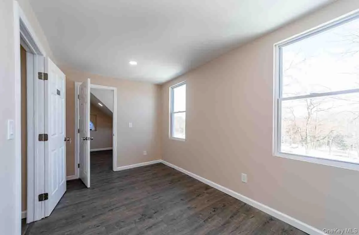 Unfurnished room featuring baseboards, dark wood-type flooring, and recessed lighting Unfurnished room featuring baseboards, dark wood-type flooring, and recessed lighting