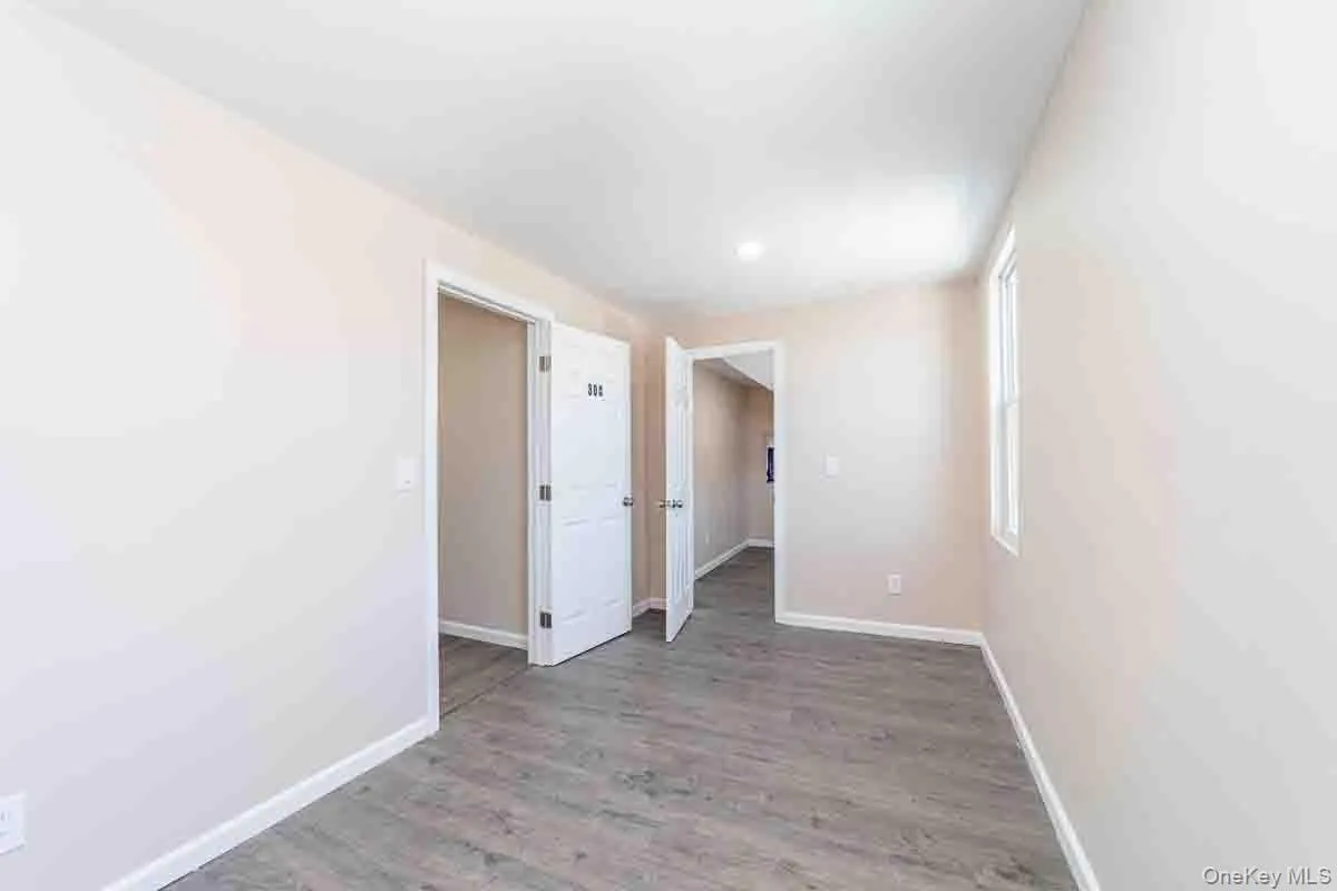 Spare room featuring baseboards and wood finished floors Spare room featuring baseboards and wood finished floors