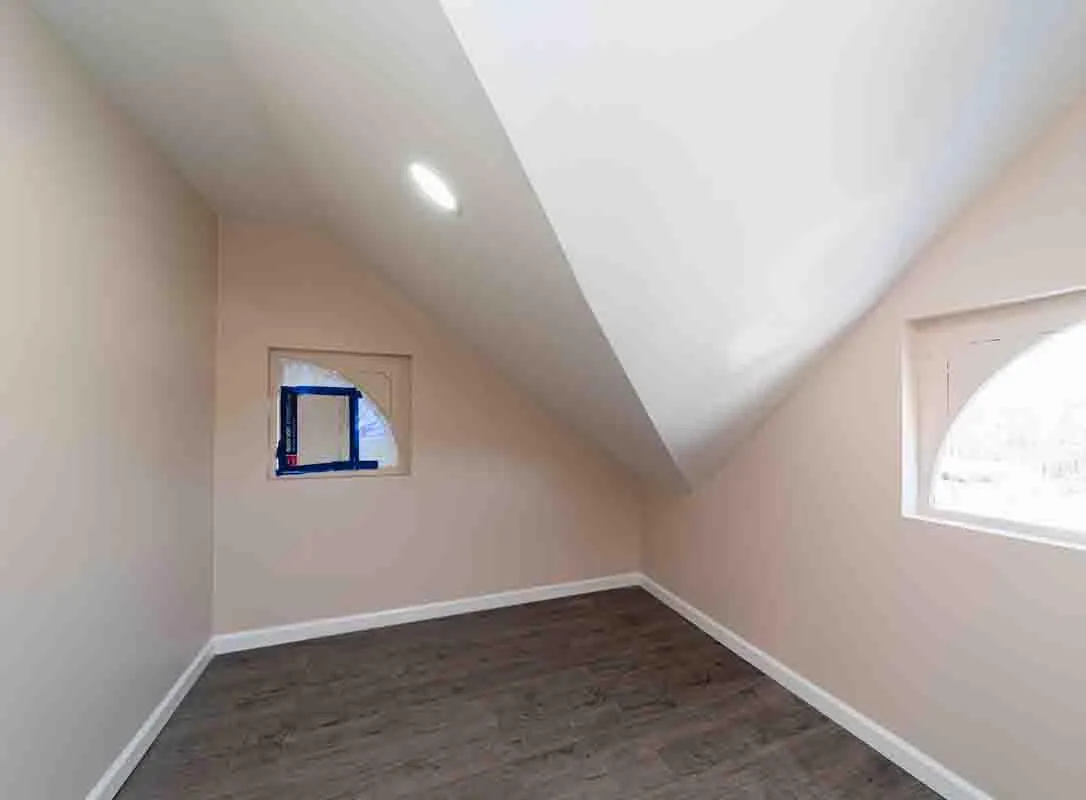 Additional living space featuring dark wood-style floors, vaulted ceiling, and baseboards Additional living space featuring dark wood-style floors, vaulted ceiling, and baseboards