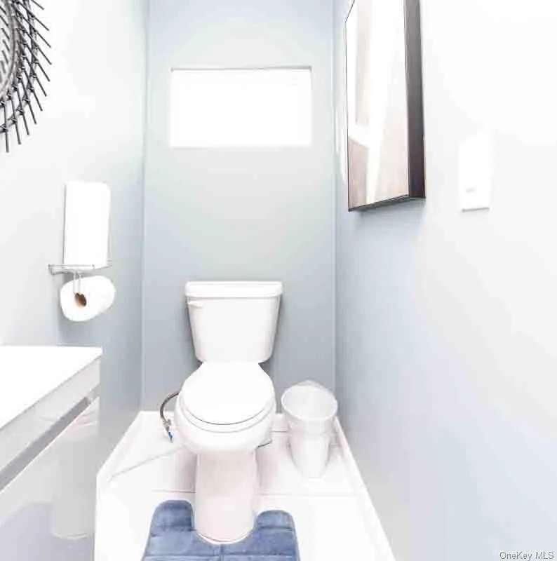 Bathroom with toilet, baseboards, and tile patterned floors Bathroom with toilet, baseboards, and tile patterned floors