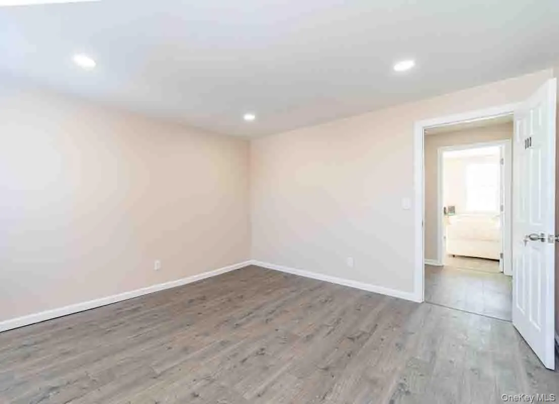 Spare room featuring recessed lighting, baseboards, and wood finished floors Spare room featuring recessed lighting, baseboards, and wood finished floors