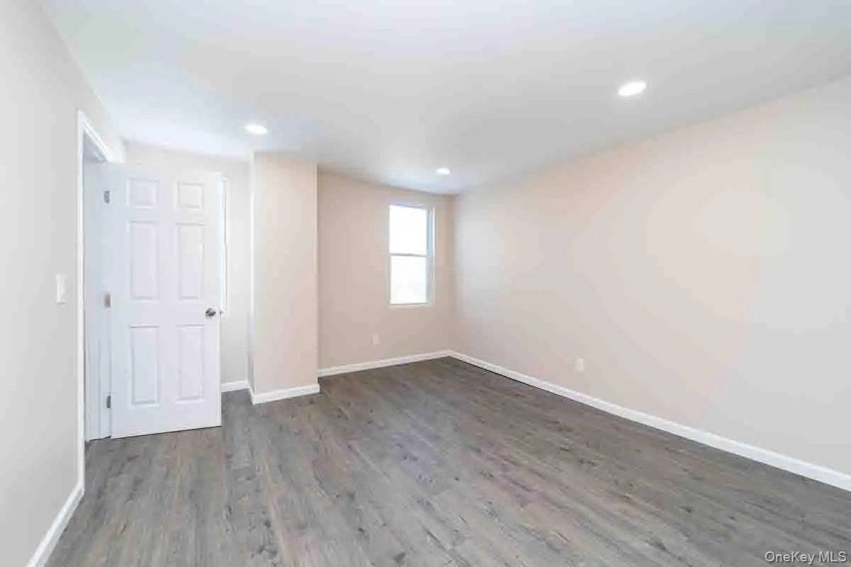 Unfurnished room with baseboards, dark wood finished floors, and recessed lighting Unfurnished room with baseboards, dark wood finished floors, and recessed lighting