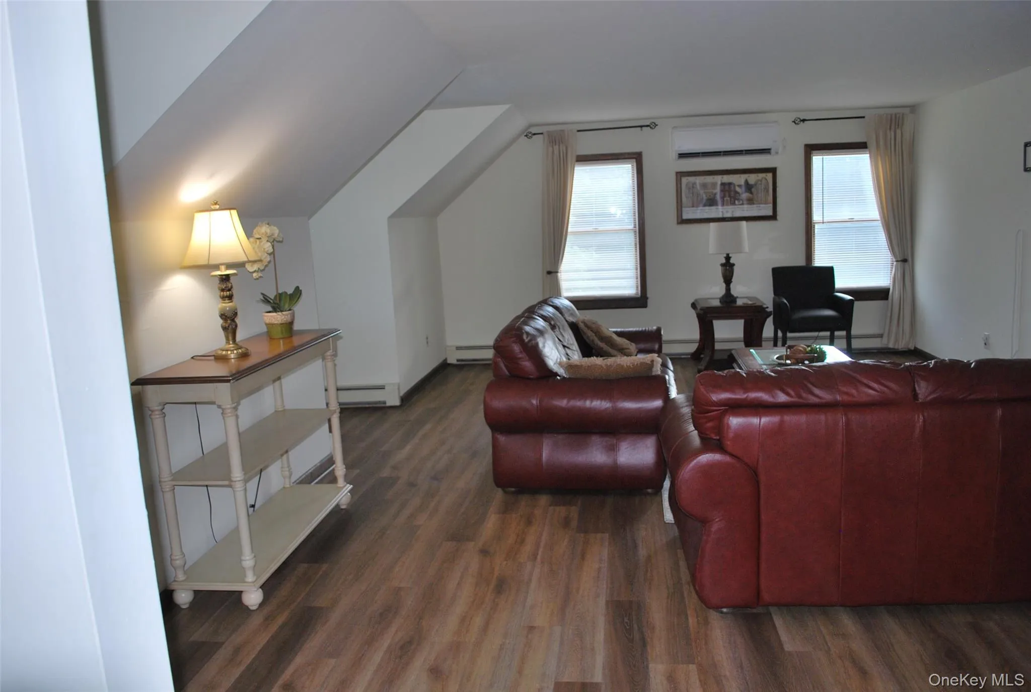 Living room with dark wood-style floors. Living room with dark wood-style floors.