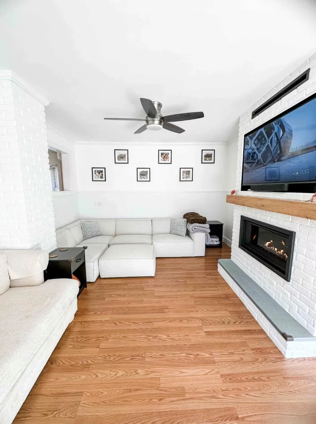 Unfurnished living room featuring a fireplace, light wood finished floors, and ceiling fan Unfurnished living room featuring a fireplace, light wood finished floors, and ceiling fan