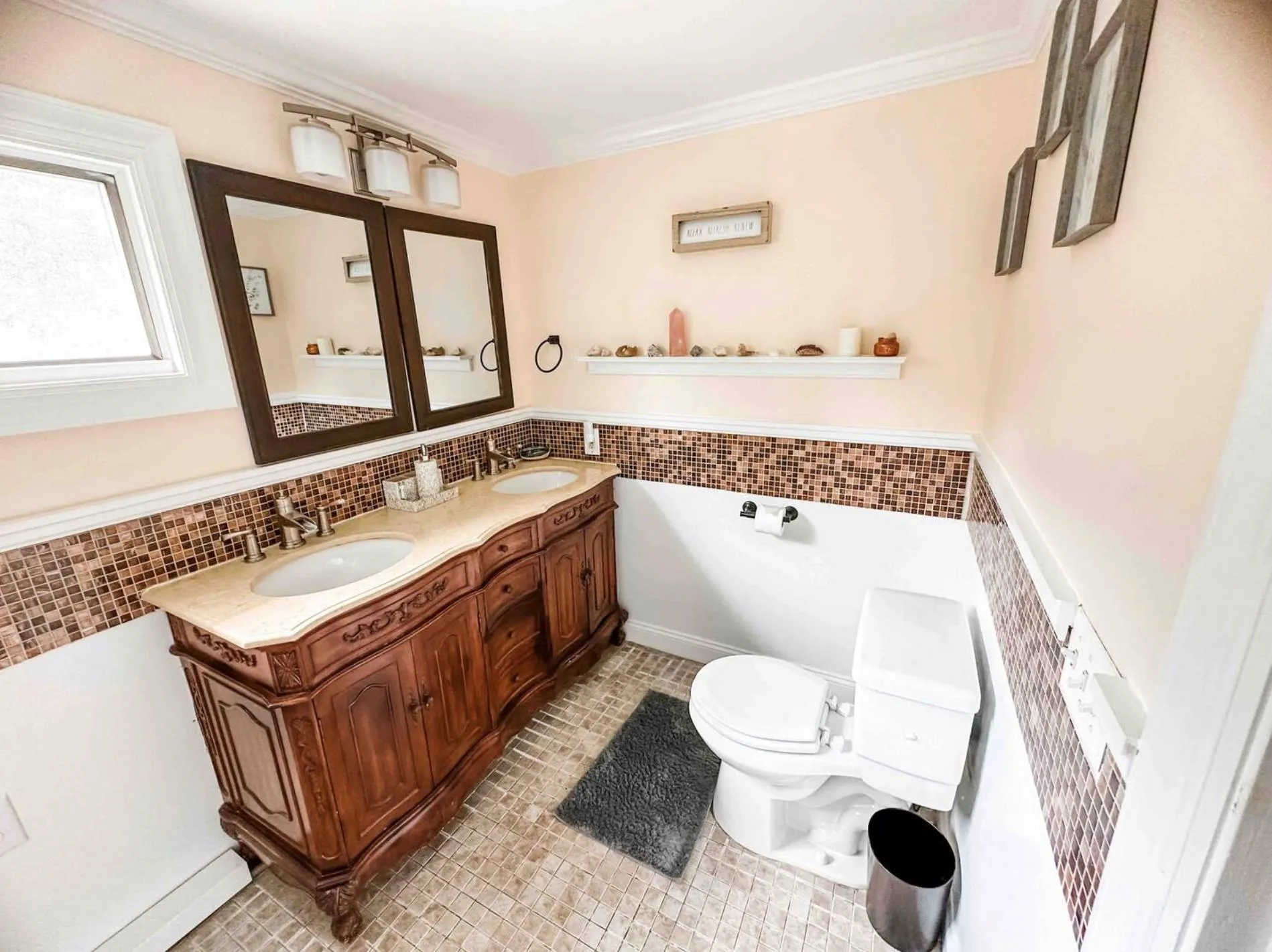 Bathroom with ornamental molding, a sink, and tile walls Bathroom with ornamental molding, a sink, and tile walls
