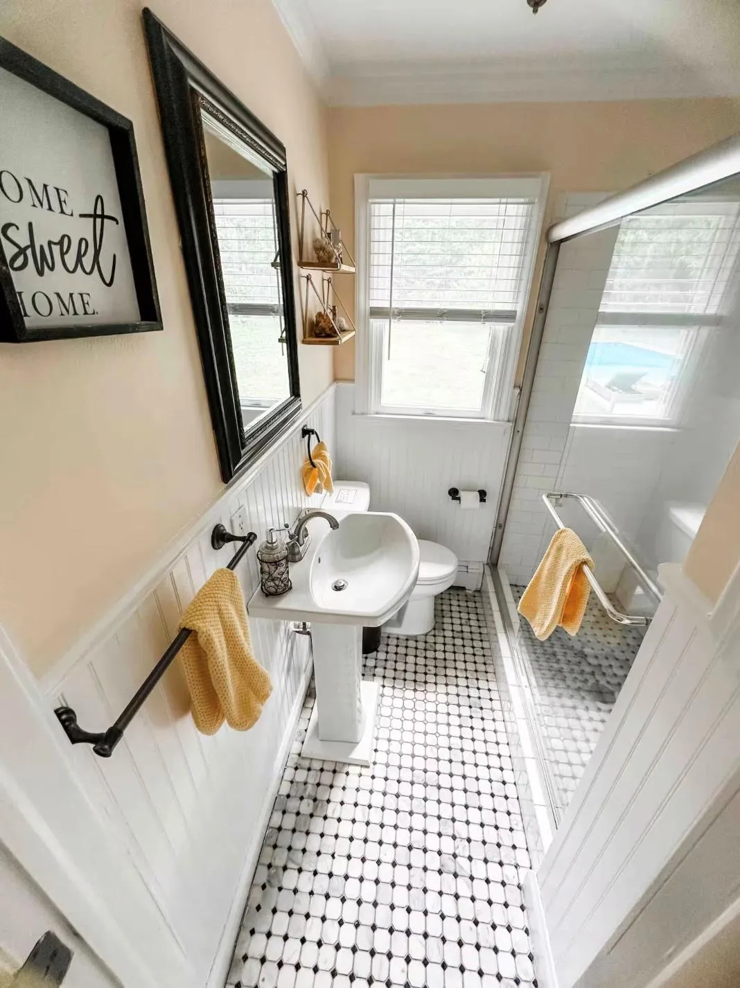 Full bath with a stall shower, toilet, a wainscoted wall, ornamental molding, and tile patterned flooring Full bath with a stall shower, toilet, a wainscoted wall, ornamental molding, and tile patterned flooring