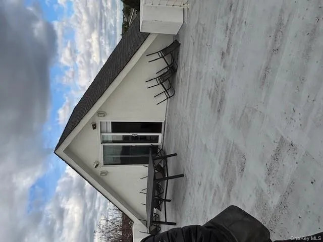 Rear view of property with stucco siding and a shingled roof Rear view of property with stucco siding and a shingled roof