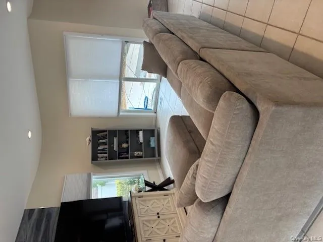 Living room featuring light tile patterned floors and recessed lighting Living room featuring light tile patterned floors and recessed lighting